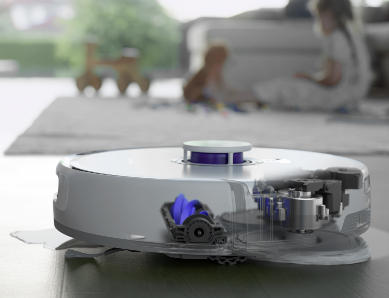 Close-up view of the Narwal Freo Z Ultra robot vacuum in action, with a transparent cutaway showing its internal components, while cleaning a play area with children.